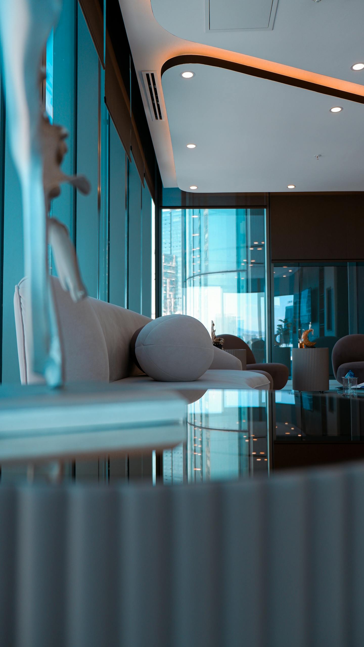 A modern lounge with sleek furniture and ambient lighting, reflecting a stylish interior design.