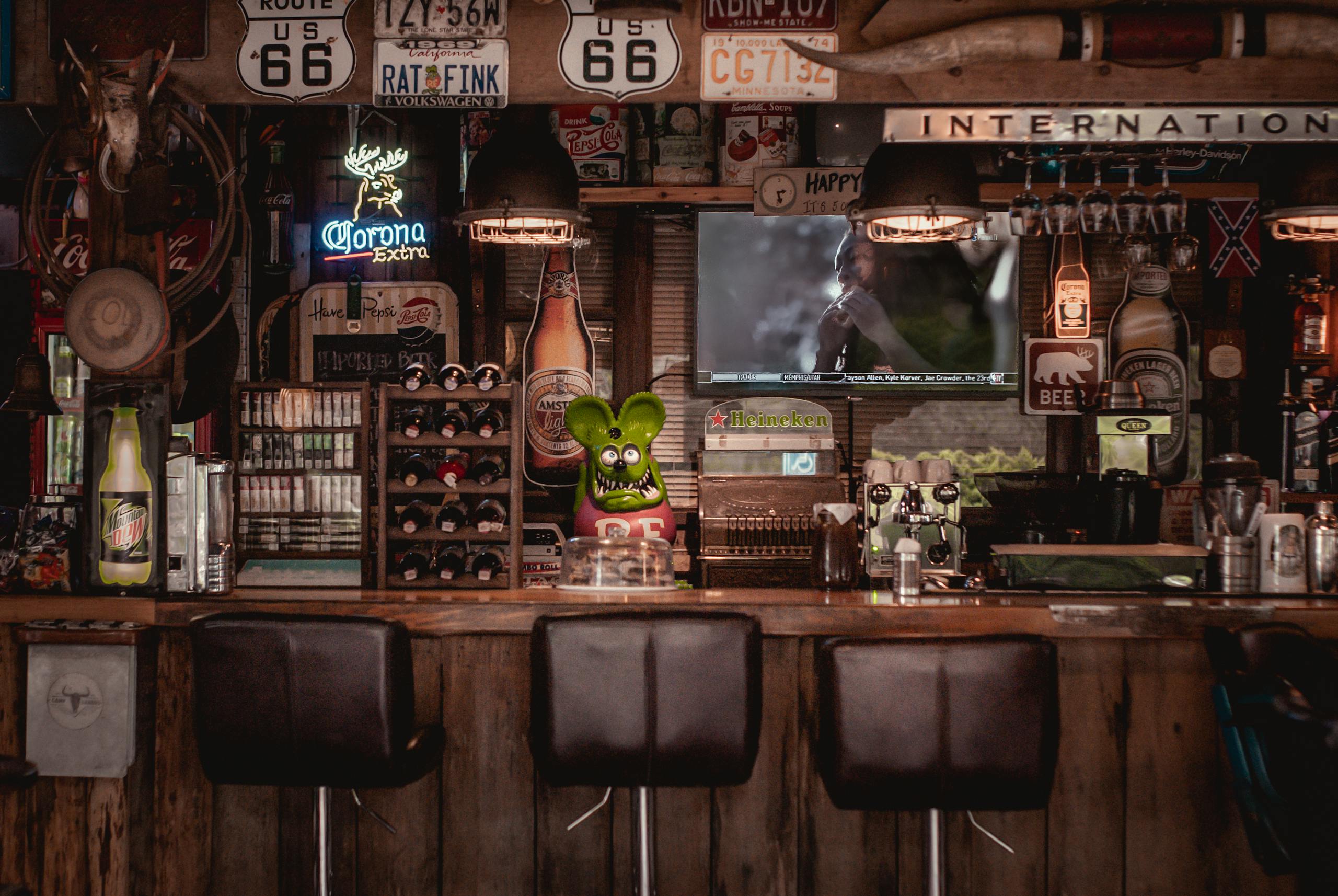 Cozy bar interior featuring Route 66 decor, rustic design elements, and classic signage.