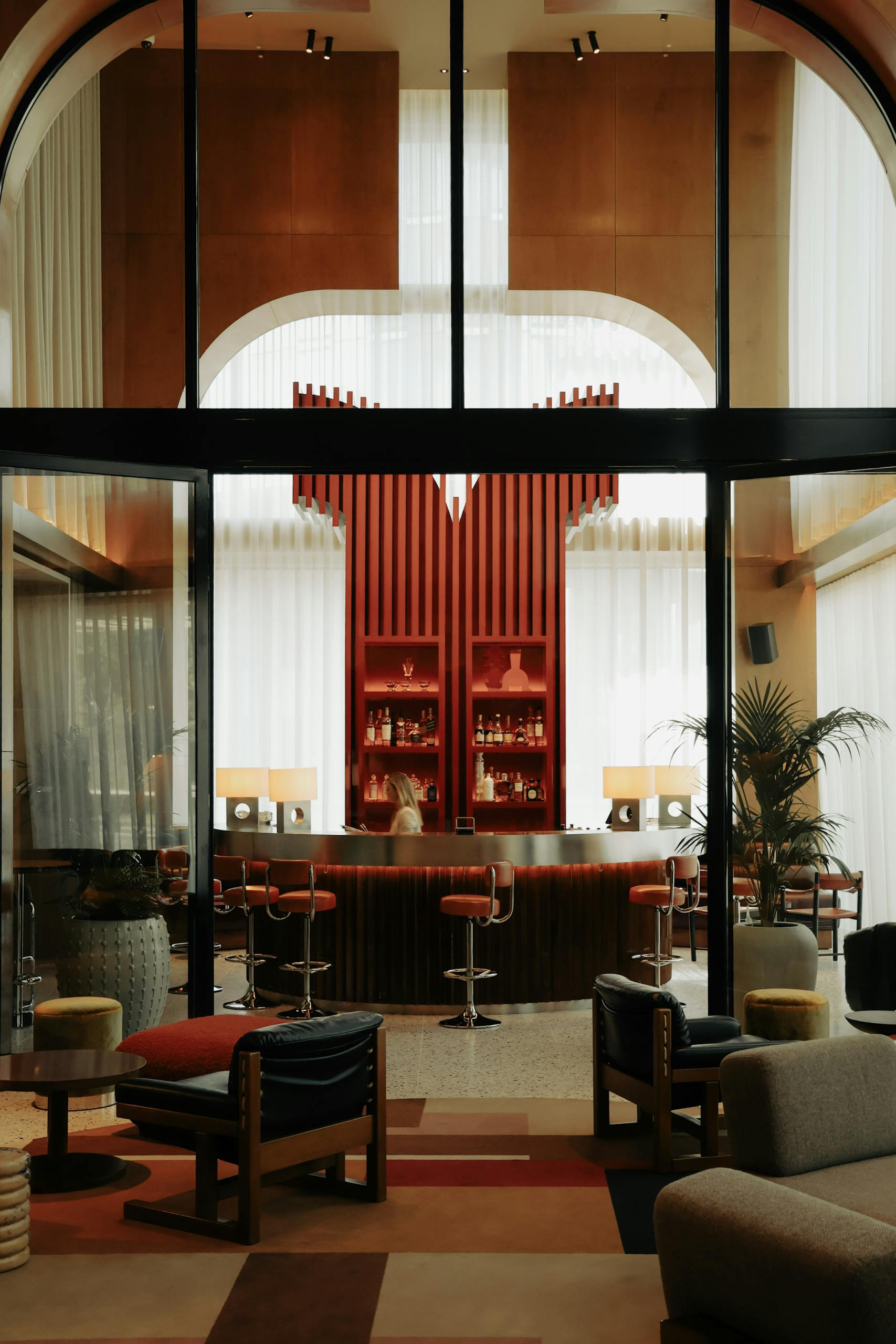 Vintage-style hotel lobby in Brussels with bar area and modern furniture.